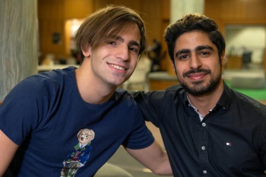 Two people arms around each other, smiling