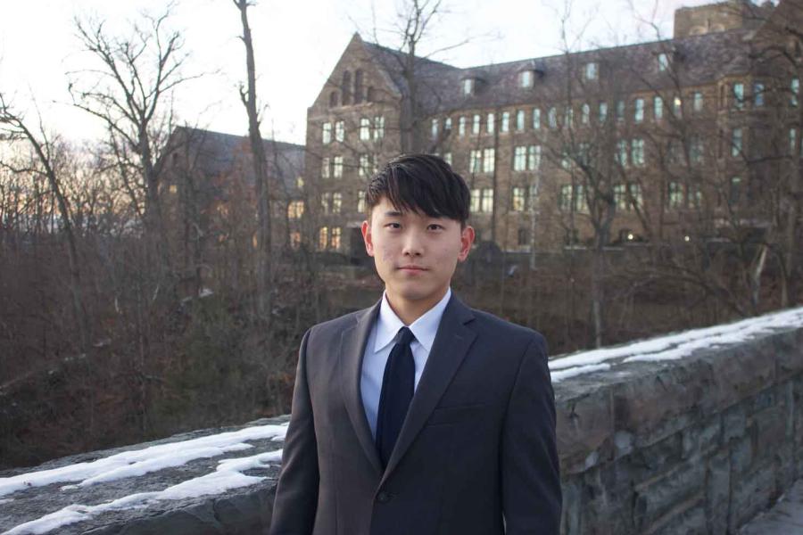 man standing outside stone wall