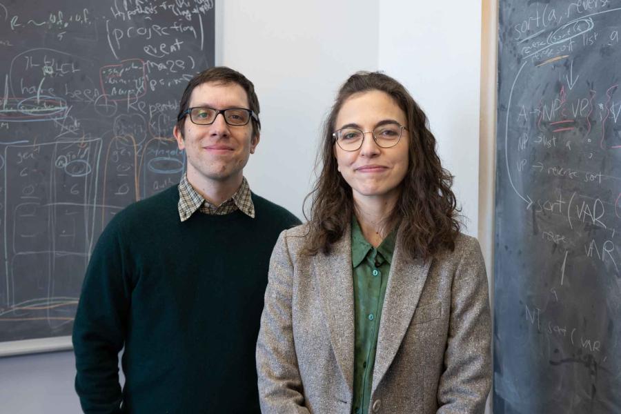 man and woman in front of chalkboard