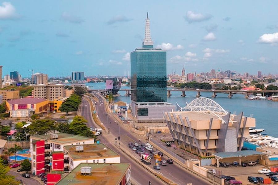 City street winds past modern buildings beside a river: Lagos, Nigeria