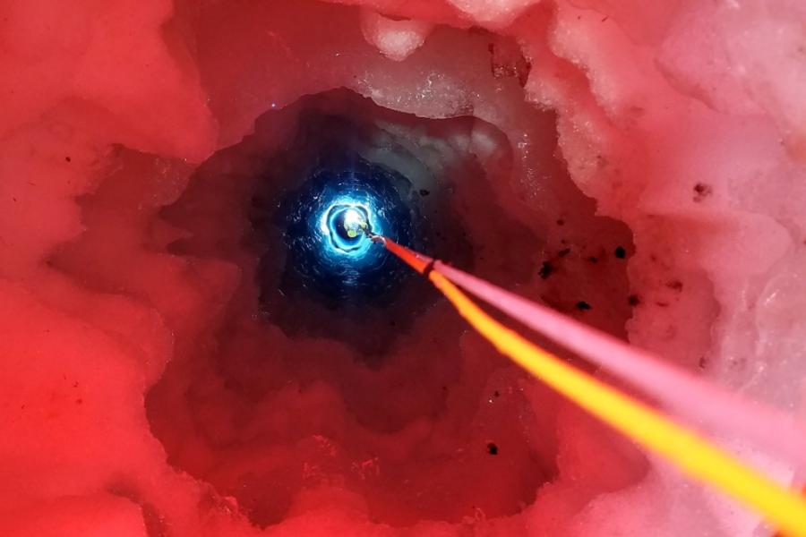 Red circle with blue light at the end and two threads leading down