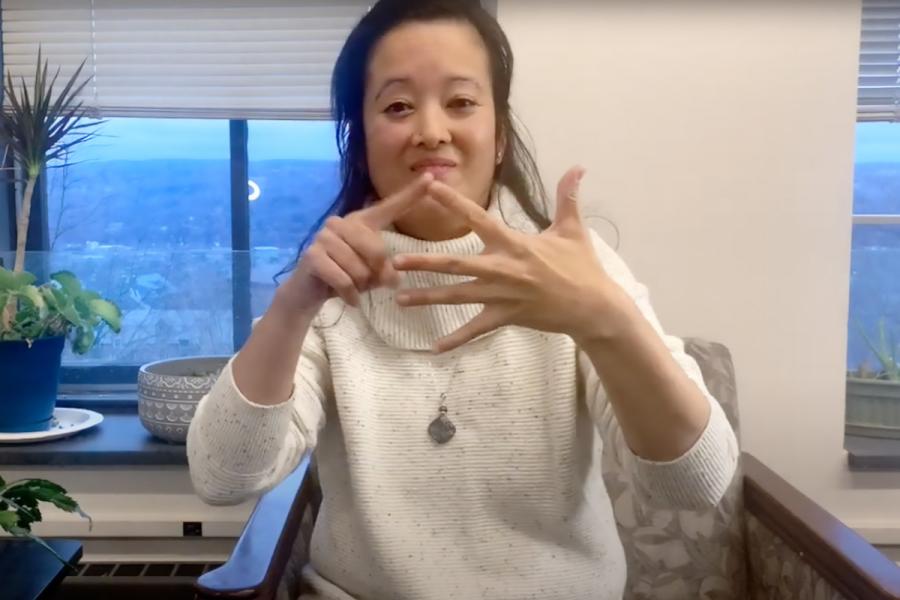 ASL professor Matilda Prestano performing sign language