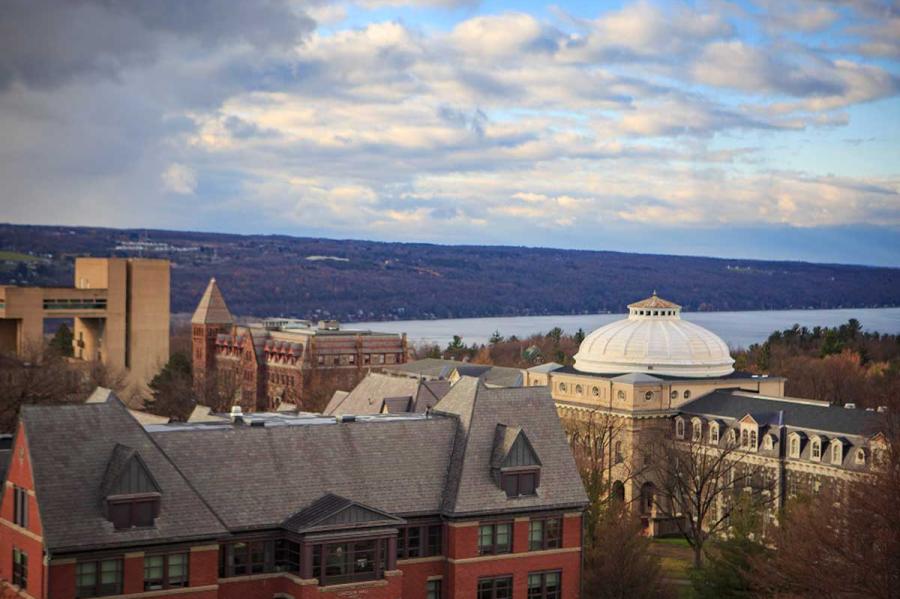 Campus buildings seen from above, under a partly cloudy sky