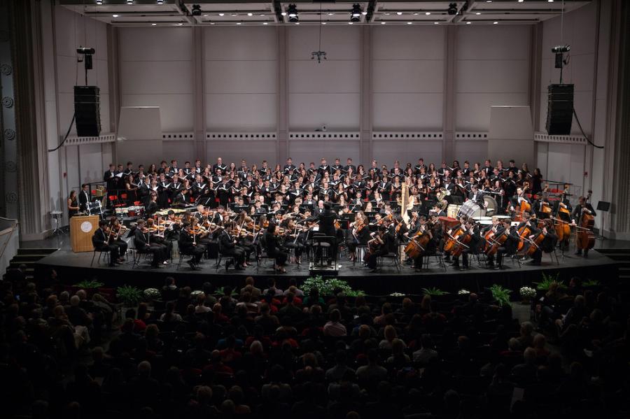 an orchestra and a chorus on a stage