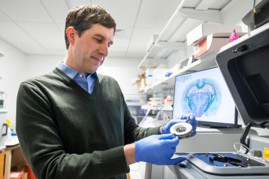 Person wearing blue gloves examines an instrument