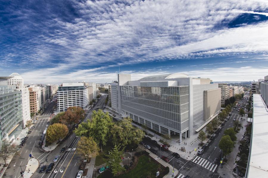 Modern building under a blue sky with textured clouds