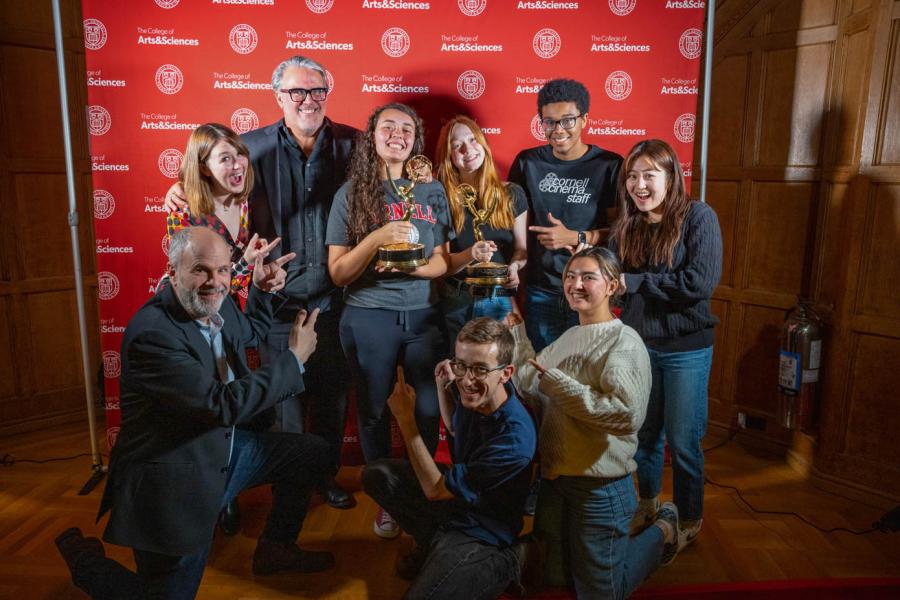 a group of people, with two holding Emmy awards