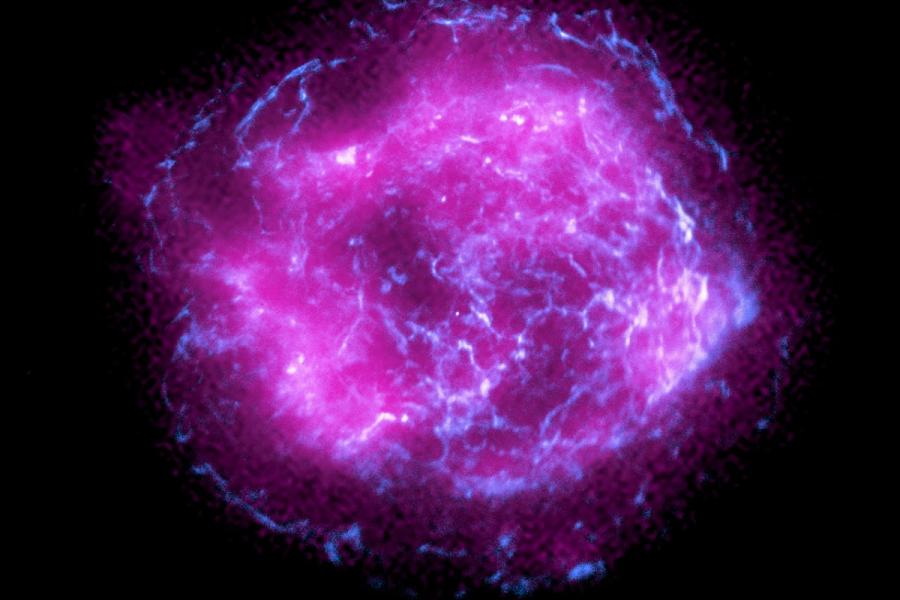 Bright pink circle shot through with blue against a black background