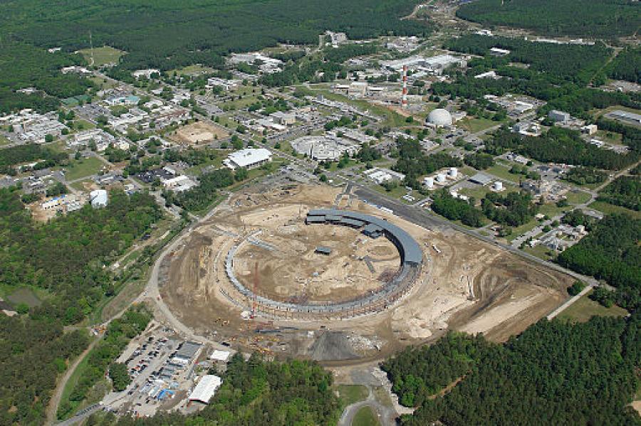 The circular accelerator ringed by buildings surrounded by a vast area of solid trees