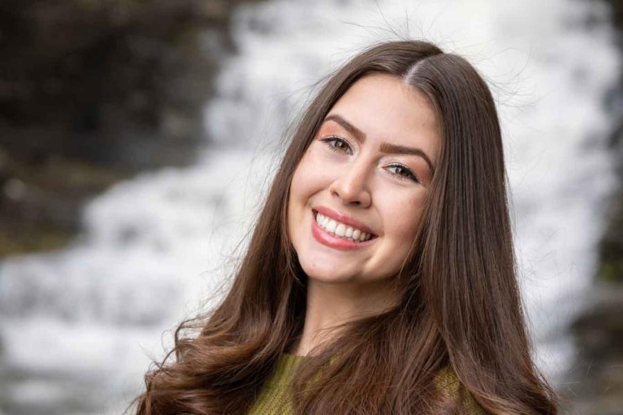 woman in front of waterfall
