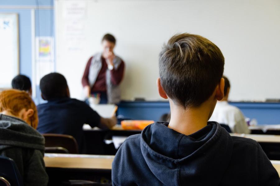 Students in a classroom, seen from behind