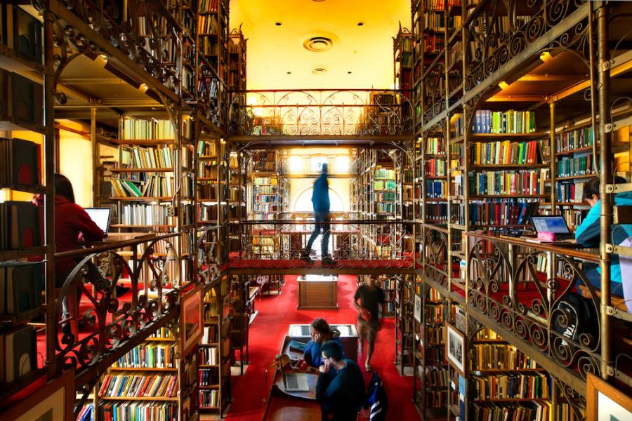 Inside a library full of elaborate book shelves