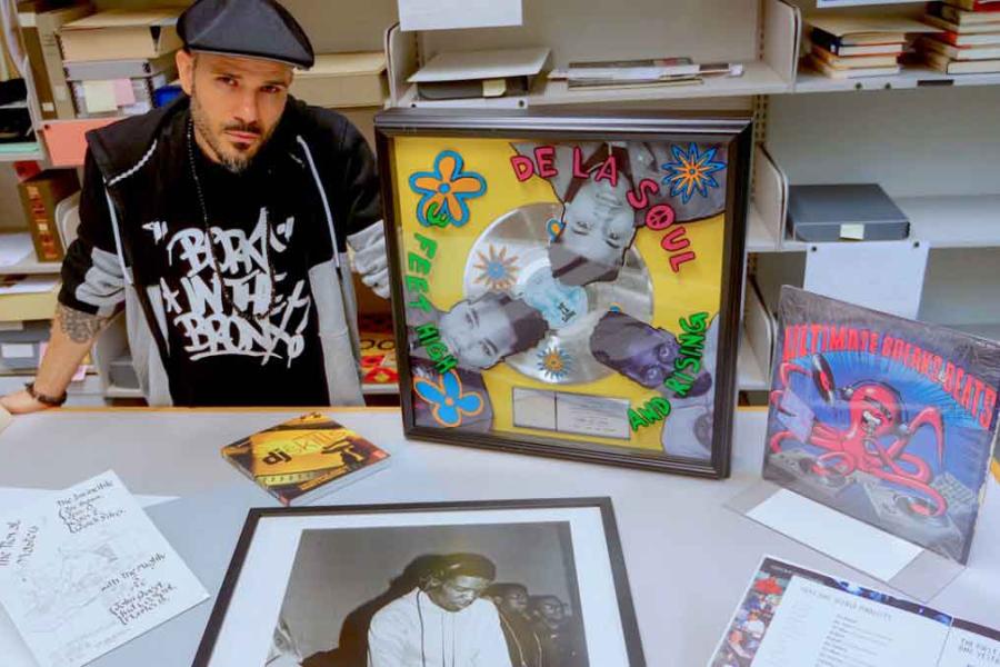 person sitting with records and other items around them
