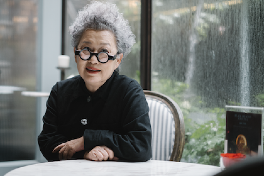  Veeraporn Nitiprapha seated at a table. 