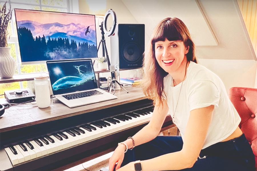 Person sitting in a red chair in front of a keyboard