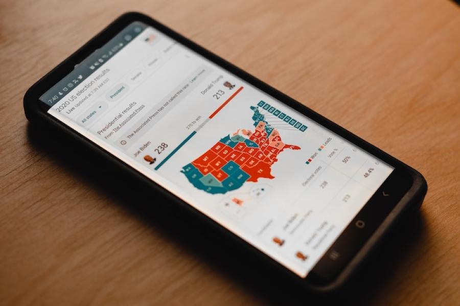 smart phone on a table, showing an image of the U.S. map