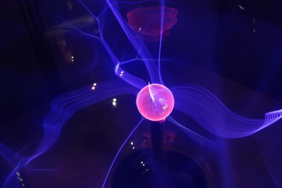 pink ball suspended in a purple field