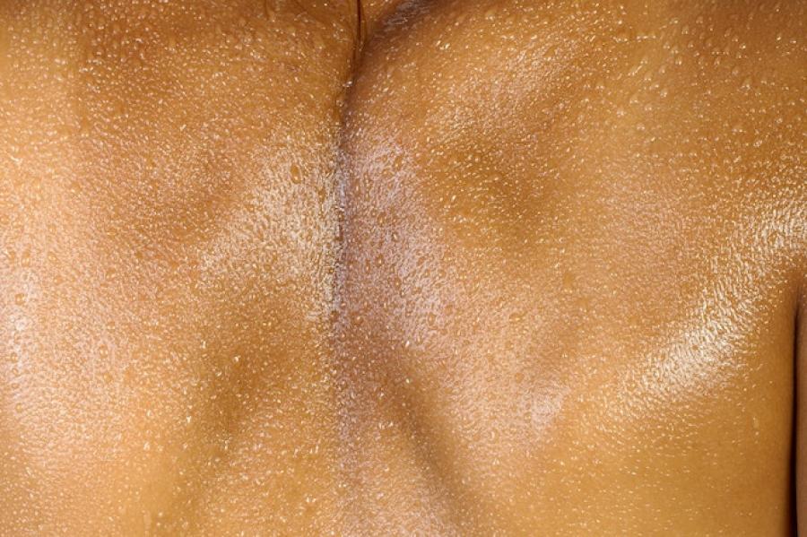 Person's back, covered with water droplets