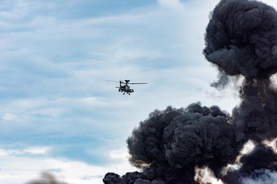 Helicopter flies toward a black cloud