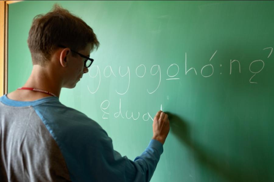 person writing on chalkboard