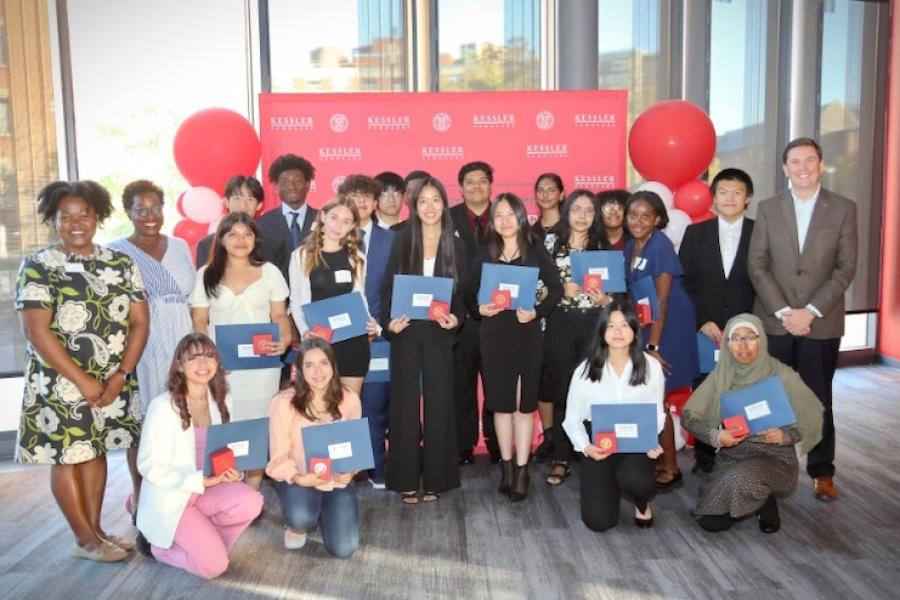 Sevearl people holding blue certificates