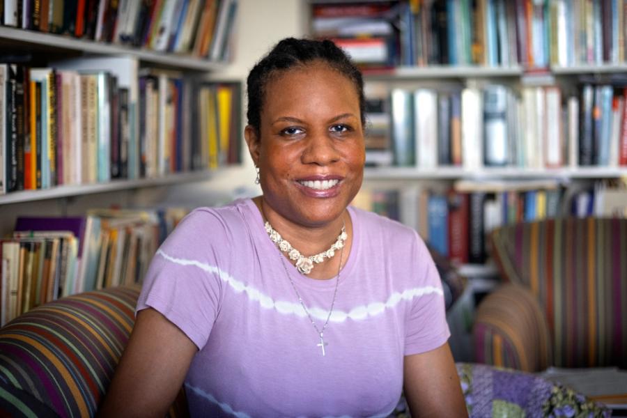 Woman sitting in front of bookshelves
