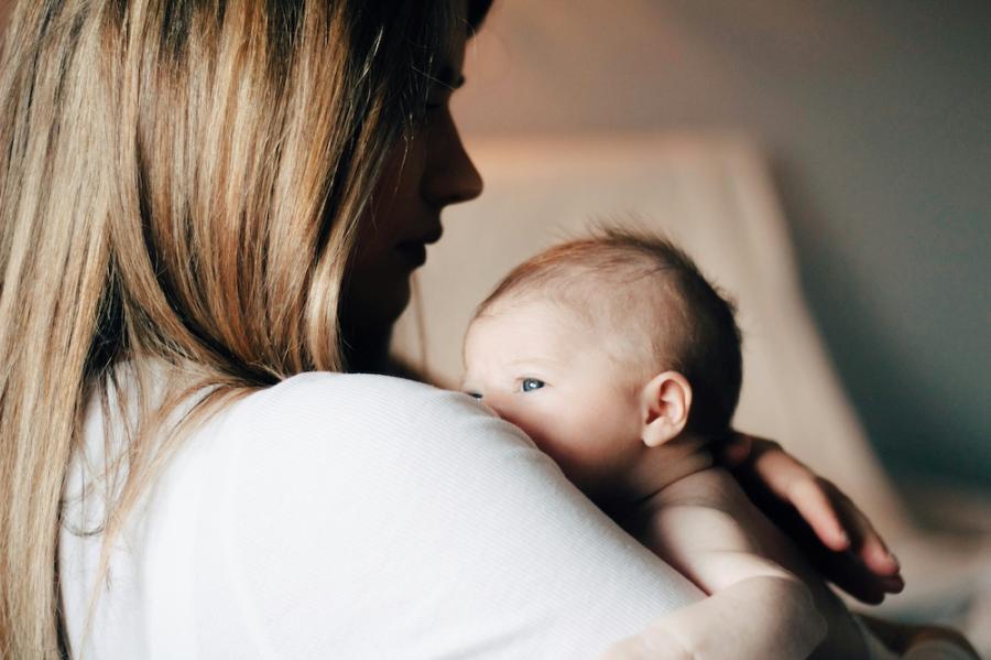 Person holding a newborn