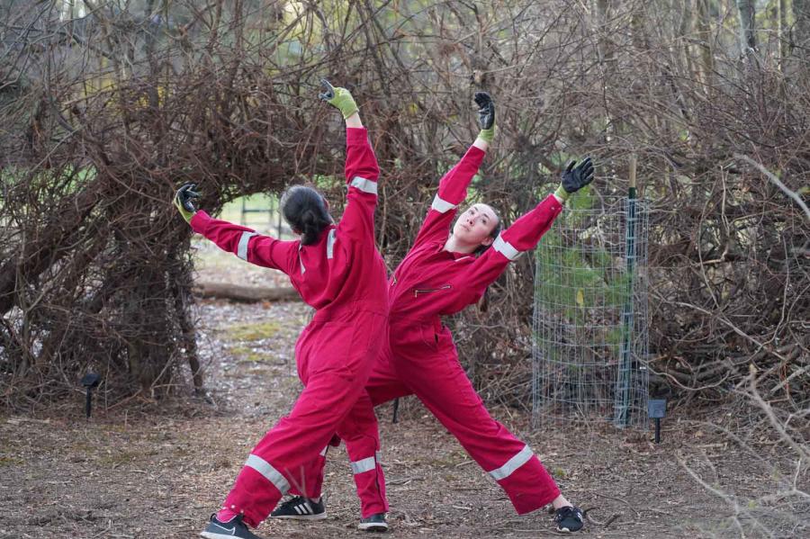 people dancing in red jumpsuits outside