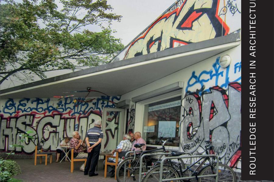 Book cover featuring an image of elderly people gathered in front of a building tagged by graffiti