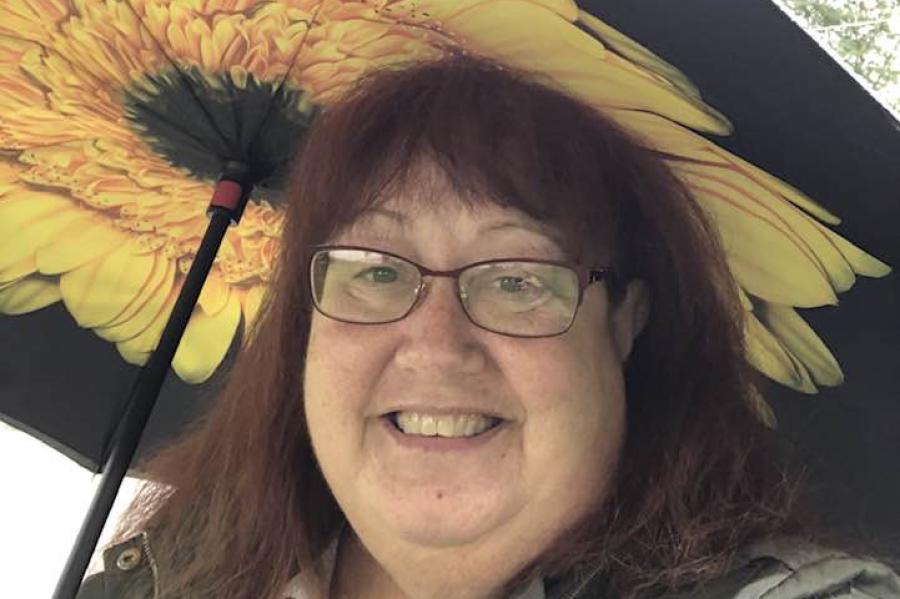 person with sunflower umbrella