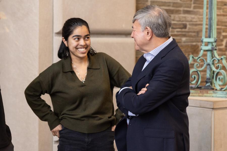 Bob Harrison smiles with a student. 