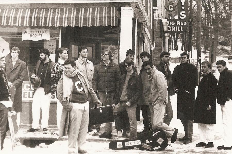 group of people standing on a street corner