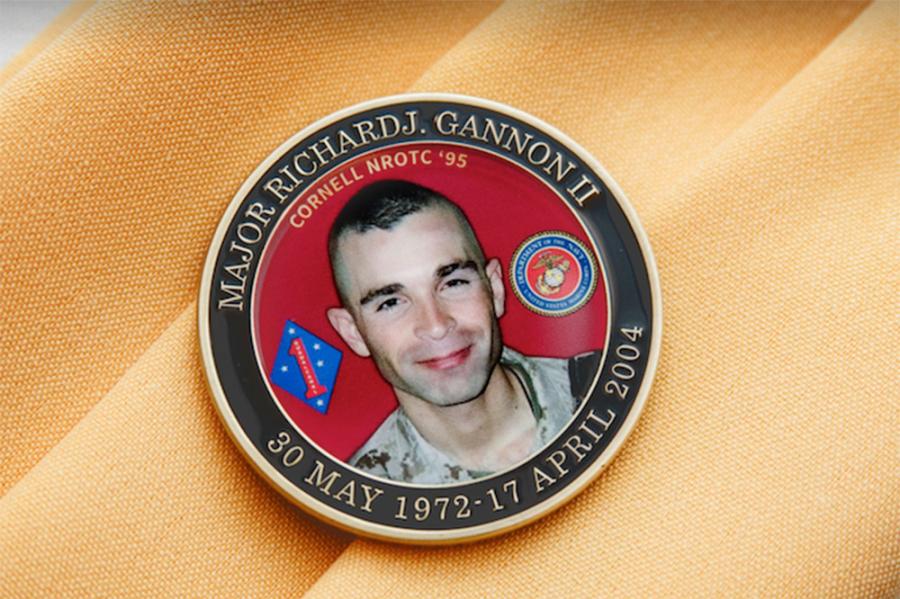 Medalion featuring a smiling face, placed on a yellow cloth