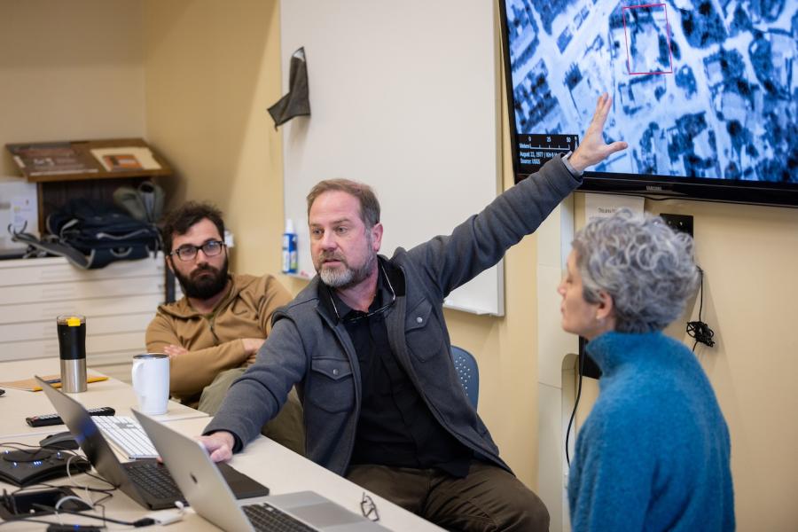 Adam Smith points to satellite image.