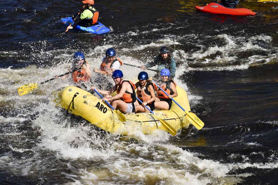 people in a whitewater rafting boat