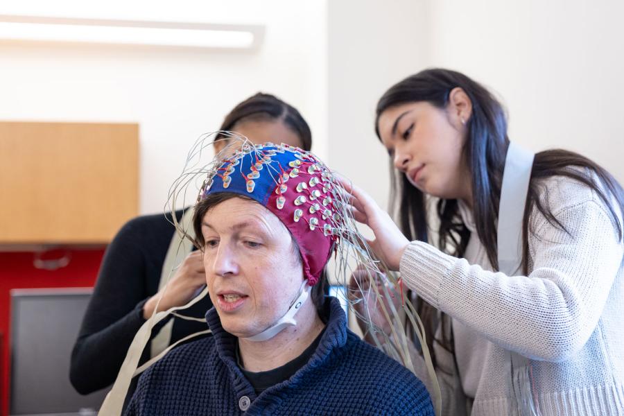 students place EEG nodes on a study participant