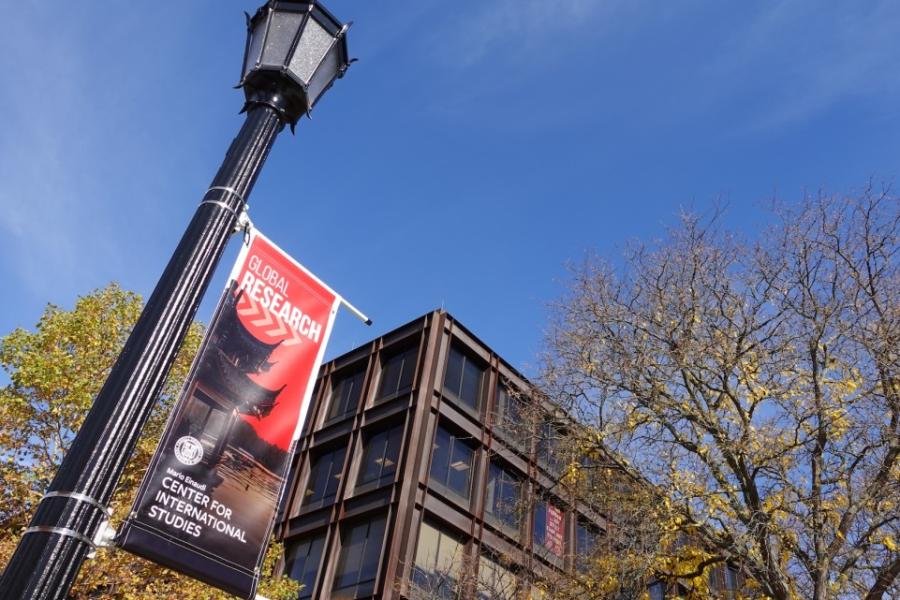 Black lamp post holding up a red poster that says Global Research