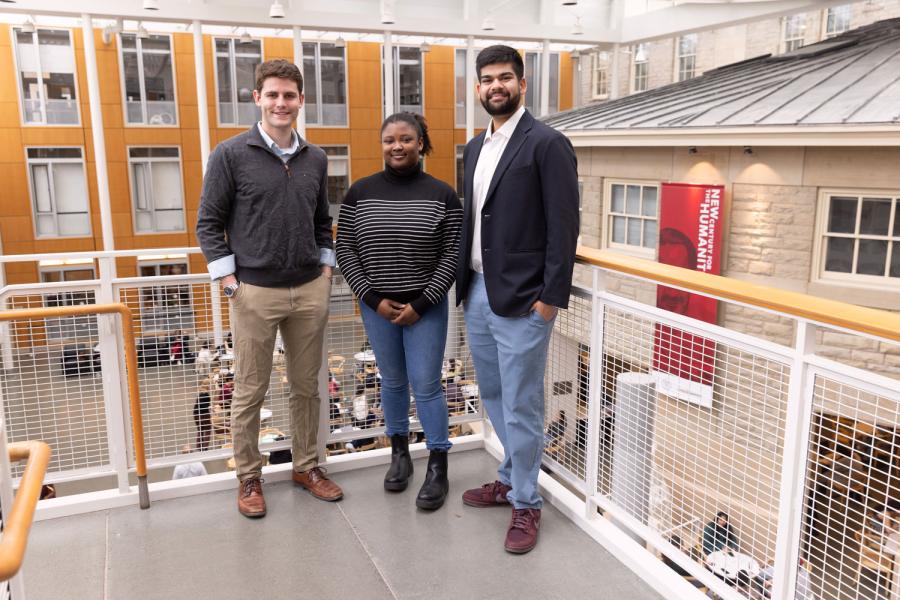 three people standing in Klarman Atrium