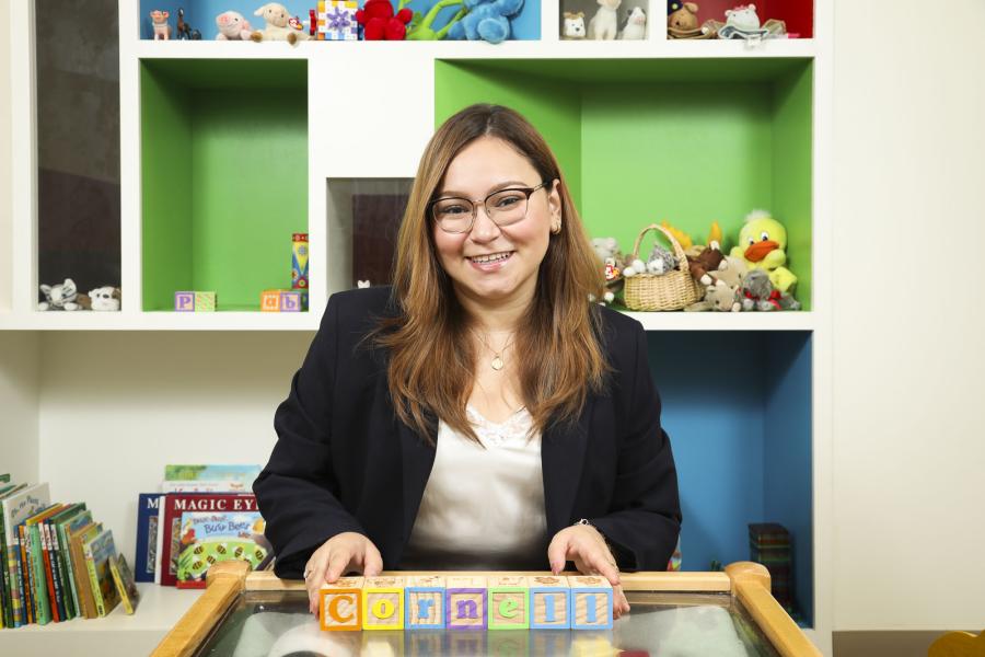 person at desk with children's blocks