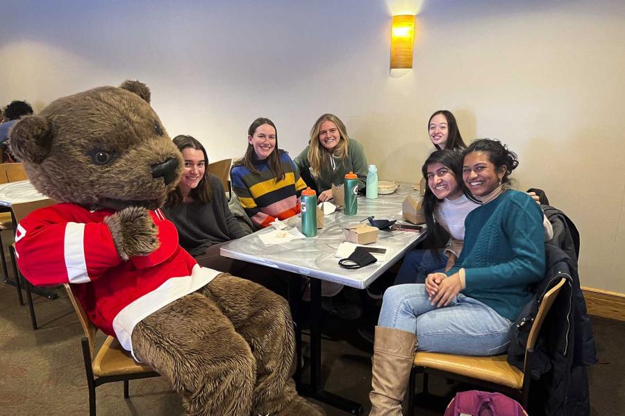 people sitting around a table with Touchdown the bear