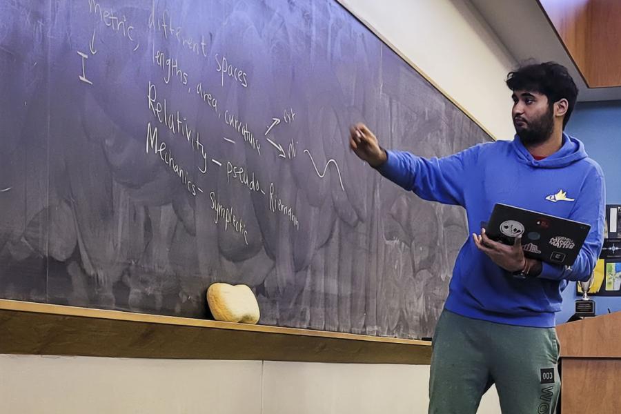 person writing on chalkboard