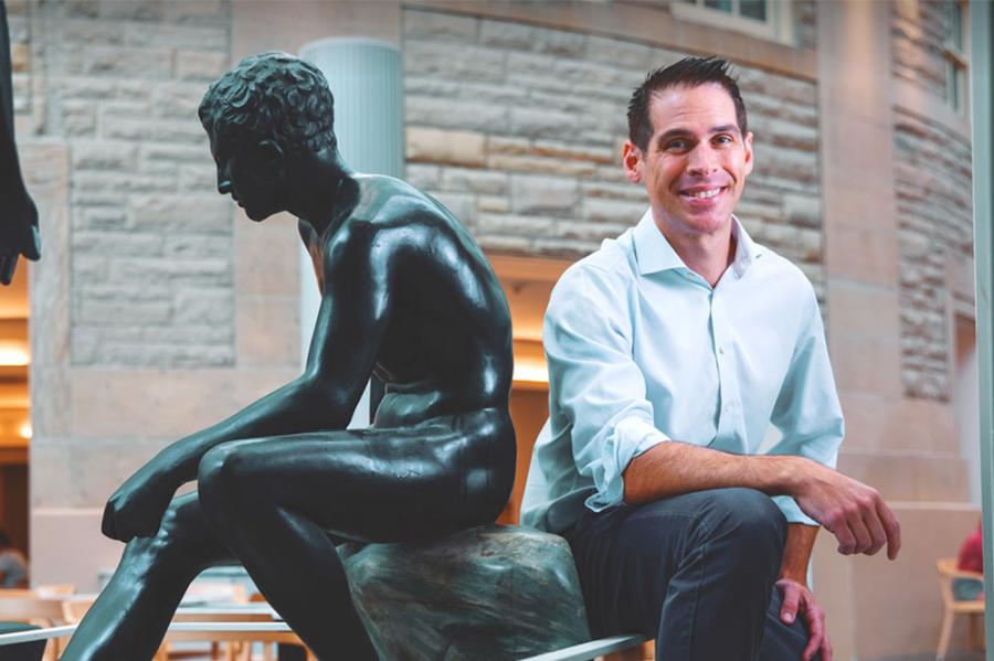 Person posing next to a statue