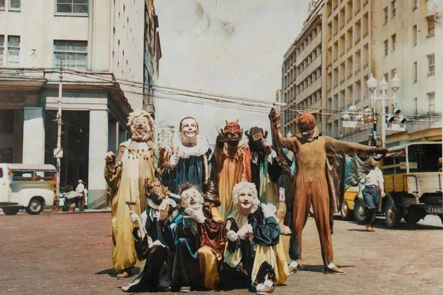 Group of four individuals in masks standing next to one another 