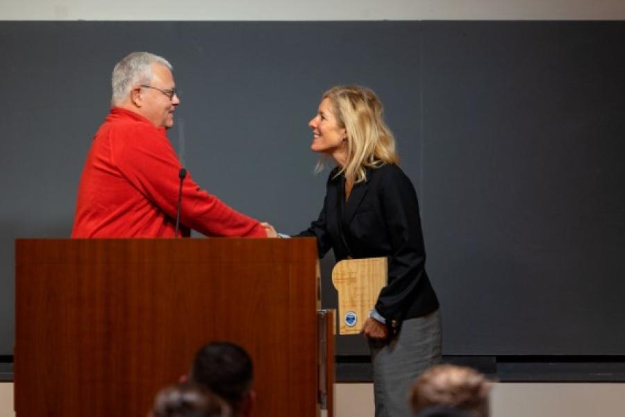 Person accepts an award at a podium