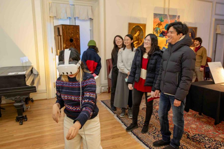a person with a virtual reality headset with other people watching