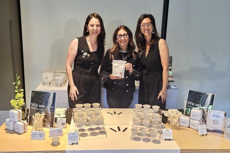 Three people stand behind a product table for "Seen Nutrition"
