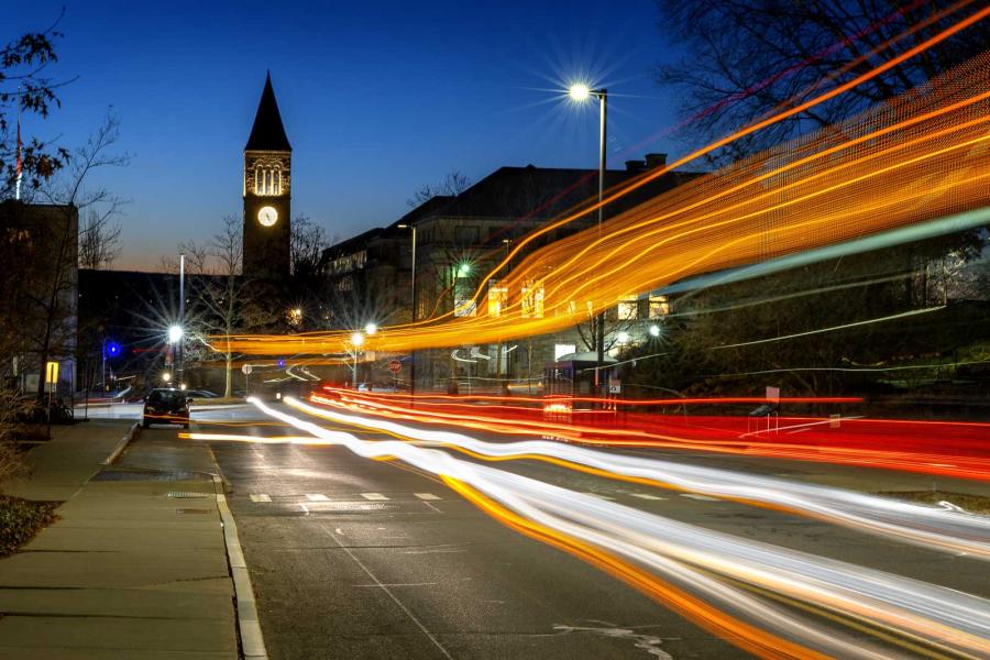 Orange red and white horizontal streaks of light under a dark blue sky, showing automobile traffic in motion at night