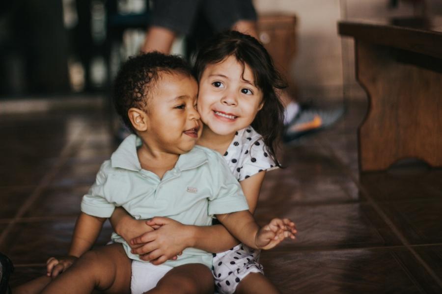 Two kids sitting on a floor