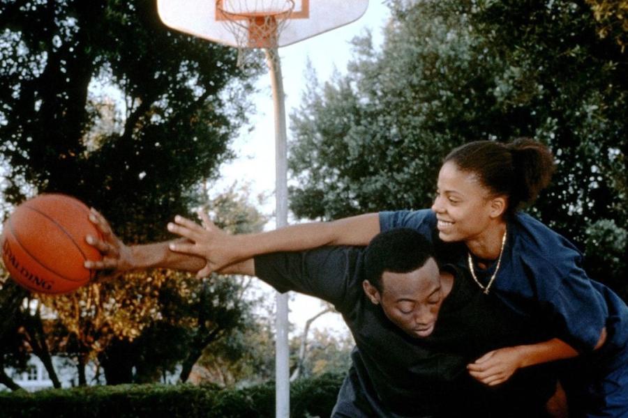 man and woman playing basketball