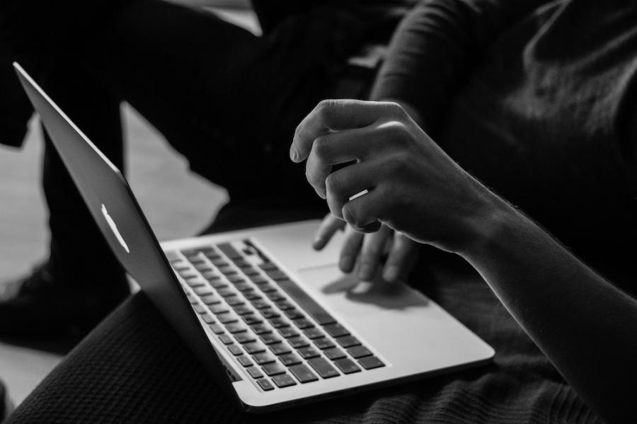 hands typing on a computer